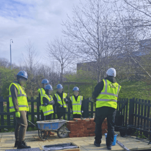 Students laying bricks during bricklaying workshop Leeds hands-on training session
